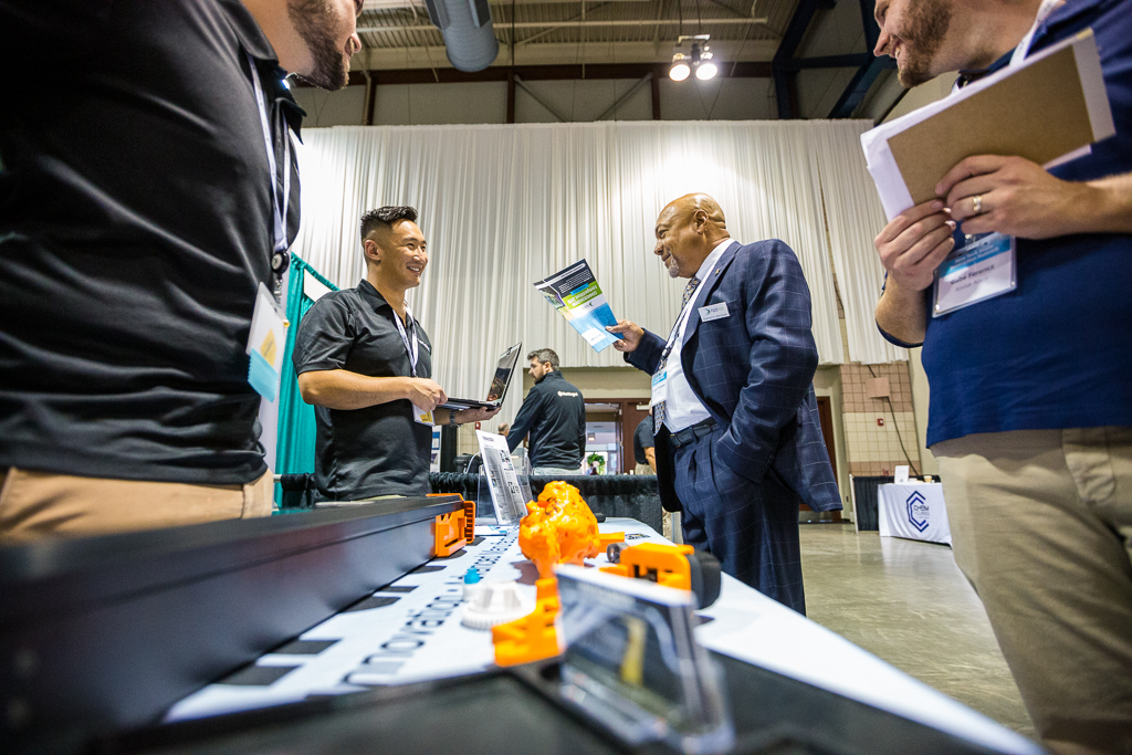 Two people speaking at an exhibitor booth